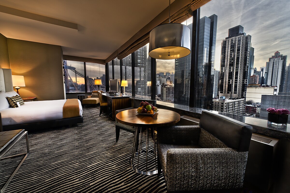 Modern hotel room with cityscape view.