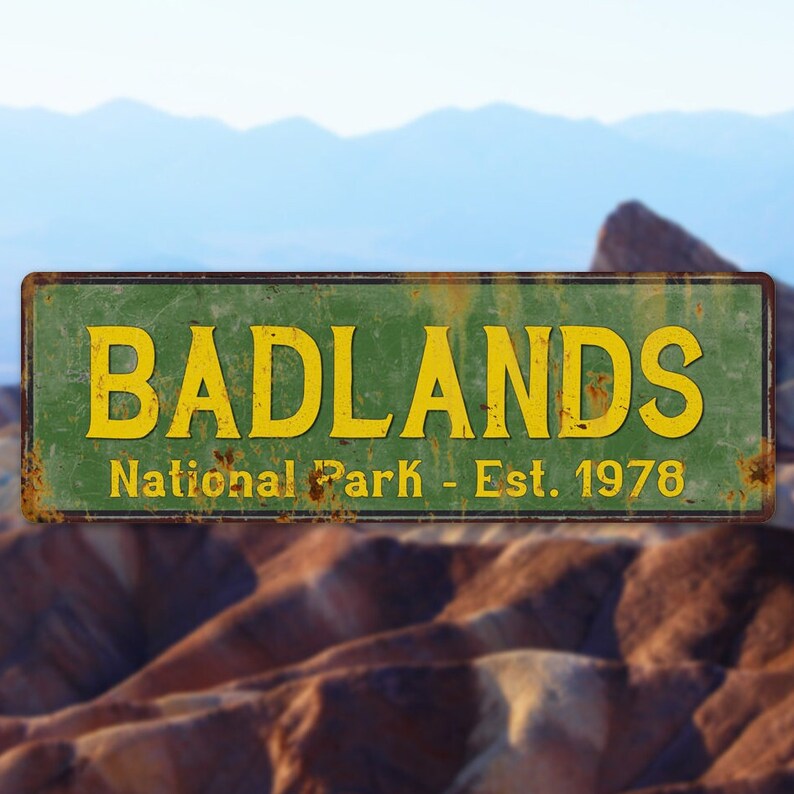 Badlands National Park sign, rocky background.