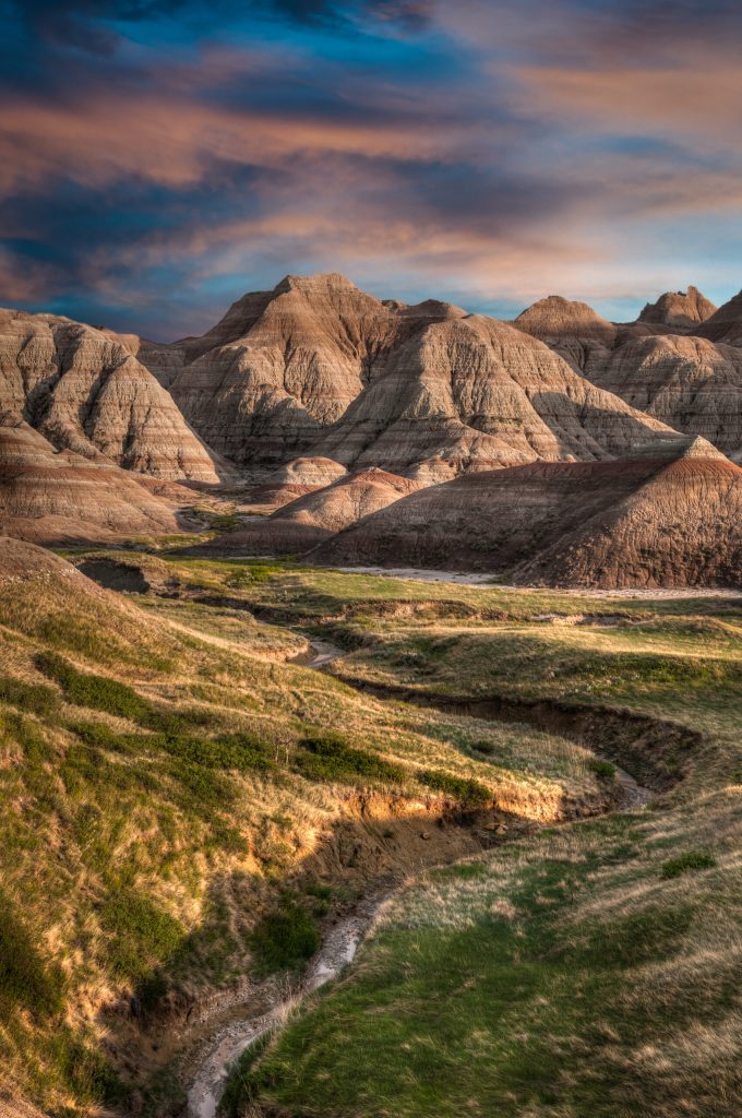 Rugged hills under a colorful sunset sky.