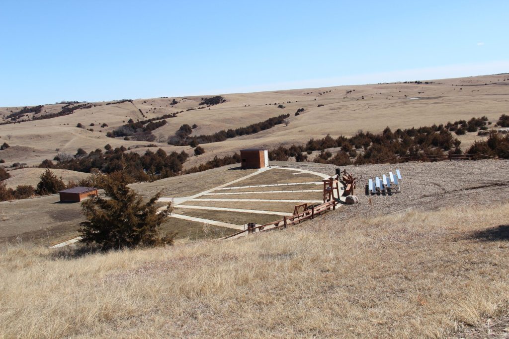 Open landscape with structures and solar panels.